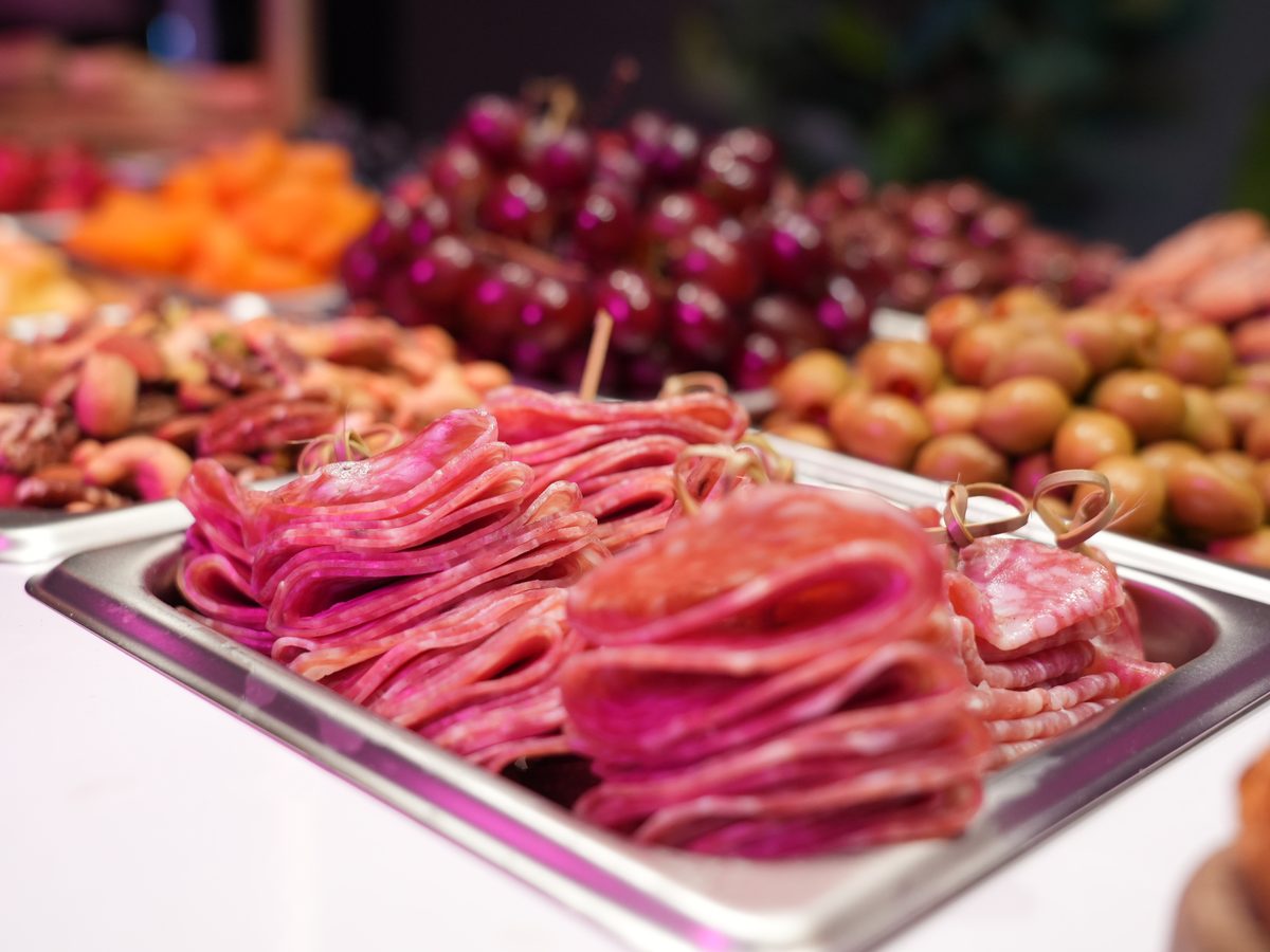 Charcuterie spread with salami, olives and seasonal fruit