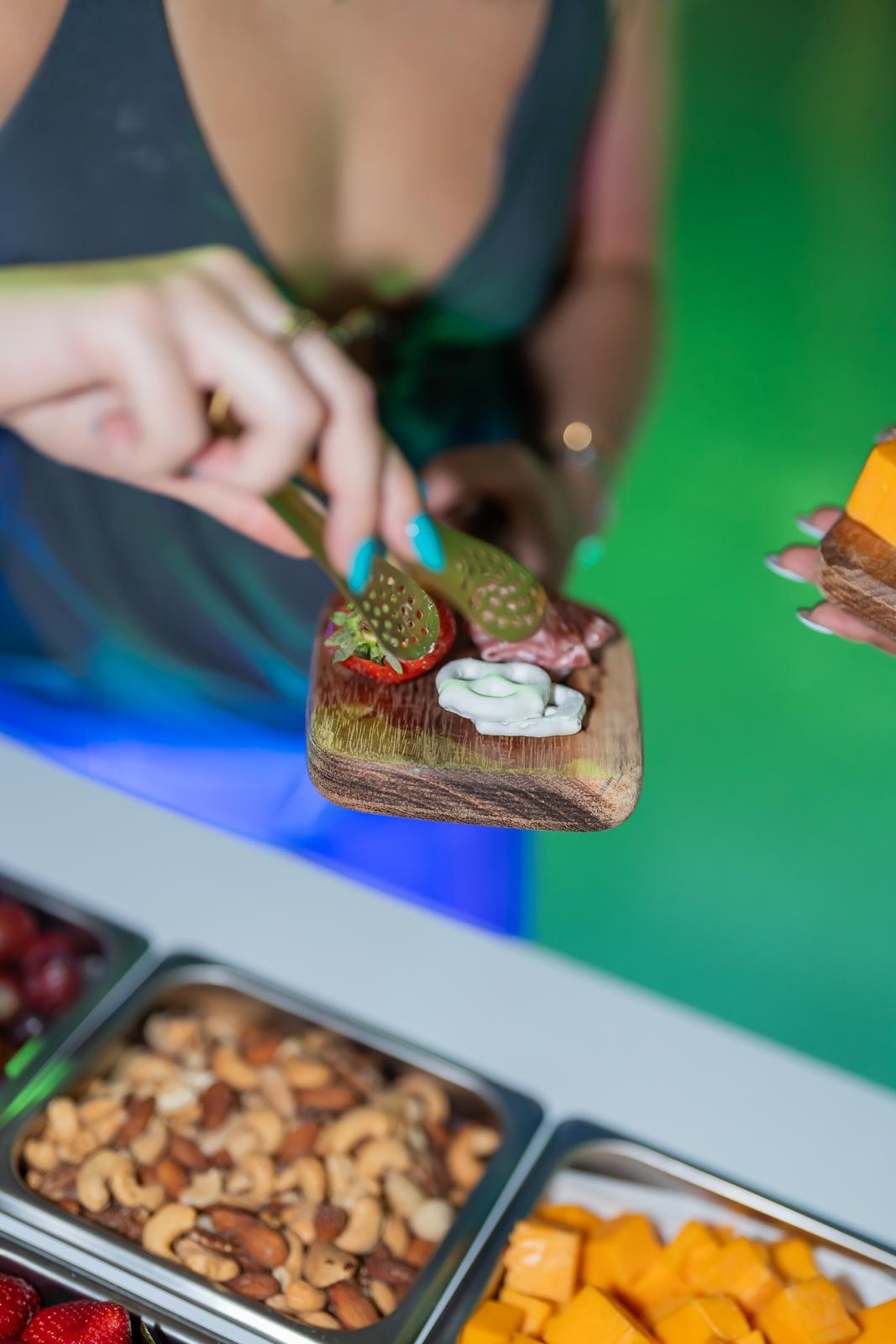 Board with strawberry, prosciutto and yogurt covered pretzels