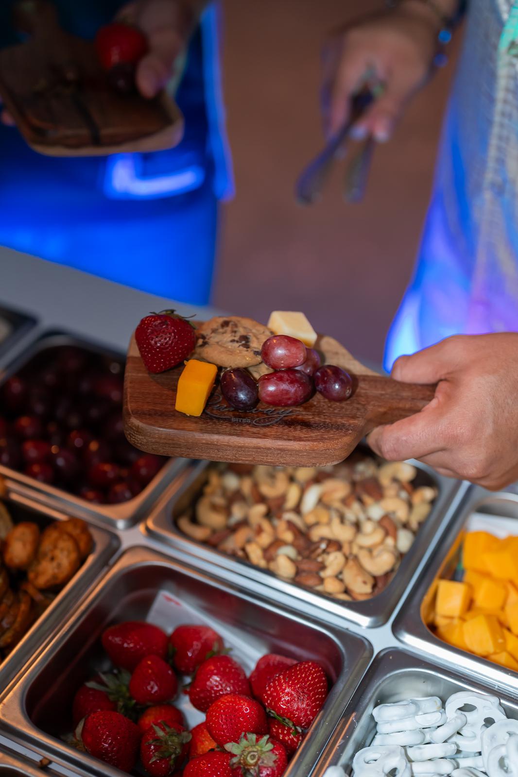 Engraved Runway Bites board with strawberry, cookie, grapes and cheese
