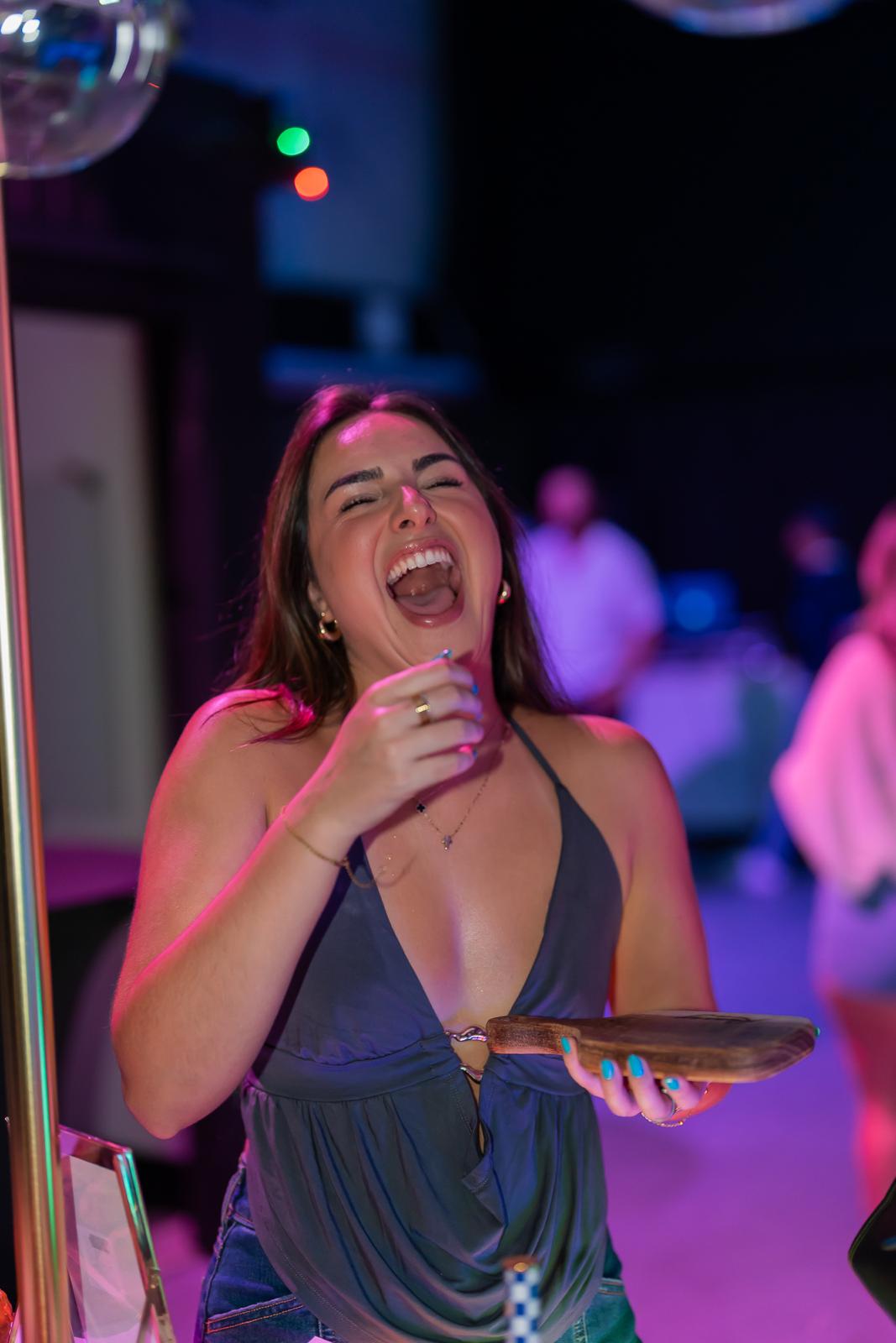 Guest laughing at the grazing bar during a Miami celebration